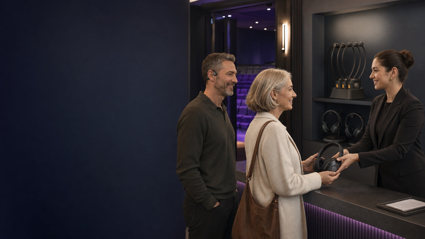 Venue staff helping guests choose a personal listening option